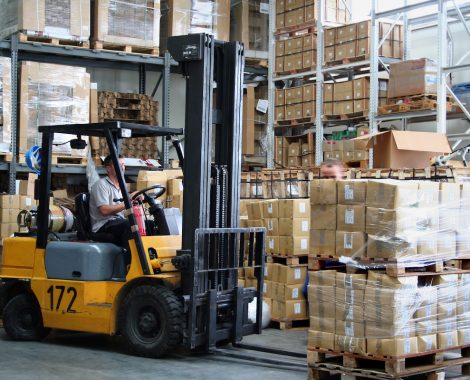 Busy warehouse with pallet trucks working